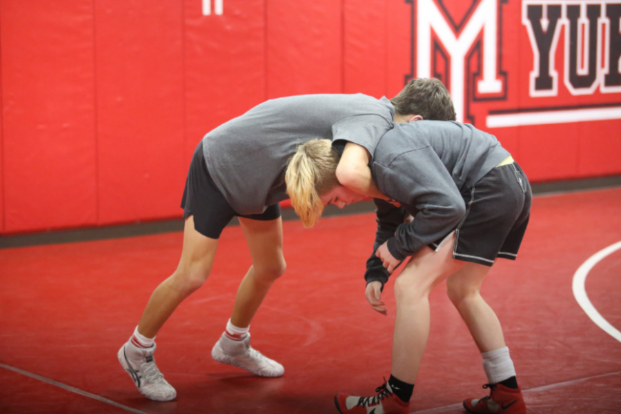 Performing a front headlock, sophomore Jackson Bodine and freshman Dillon Ryan practice before the State Wrestling Tournament. The state meet was at the OKC fairgrounds on Feb. 26.