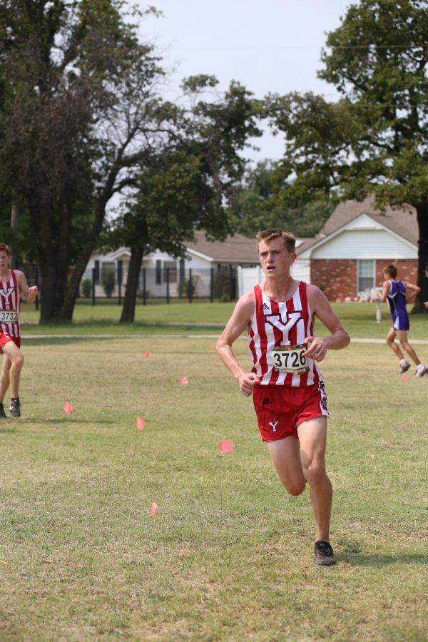 Ethan Lawson looks ahead as he rounds a corner at the cross country teams meet at Eldon Lyon Park in Bethany.