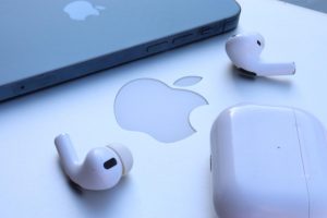 IPhone 12 Pro, AirPod Pros, and Macbook Air sittting waiting to be used.