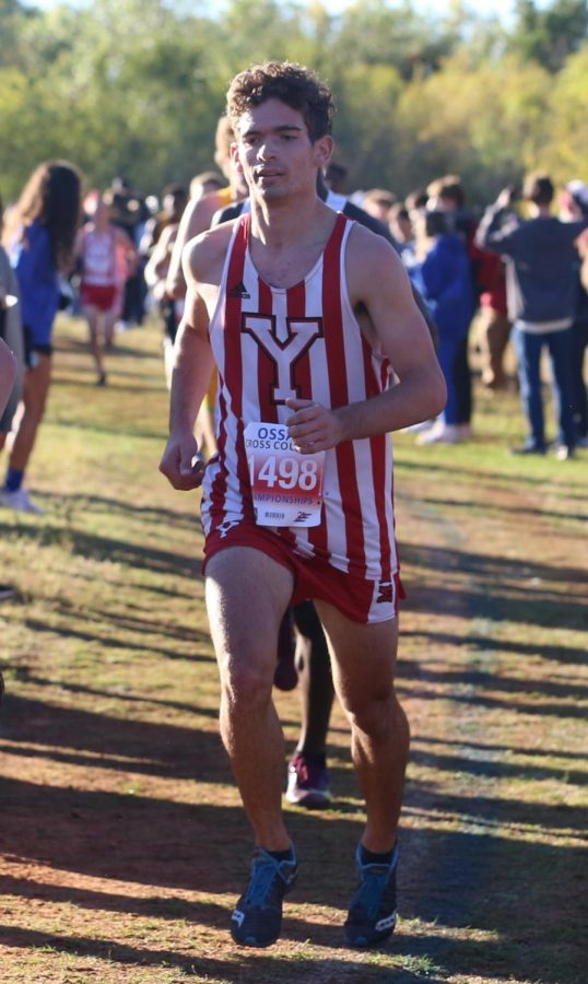 Senior Eli George leads other runners at the cross country state meet. George says the people in the sport help to keep him going. You begin to love the sport and the people in it, and then when you love the people you want to do it for them, George said.