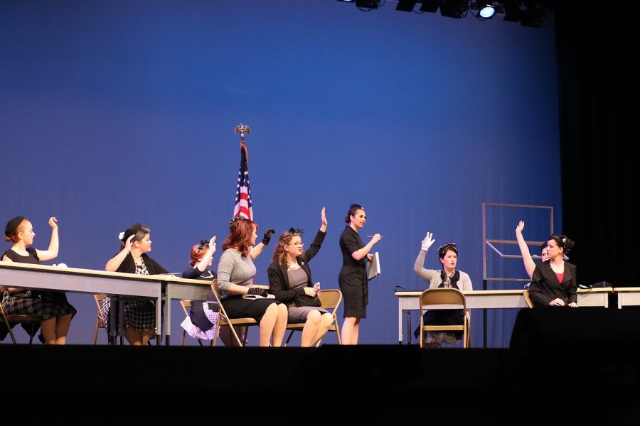 11 Angry Women raise their hands in the air for a guilty vote, one woman outlies from the crowd voting for not guilty in a murder trial. Senior Charlee Hartleys character stood up for the boy being charged, being the only one to believe his innocence.