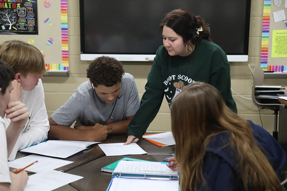 Learning about shapes and angles is not always easy. Geometry teacher Shelby Tyler assists her students with their worksheets by demonstrating and making sure they understand the assignment.