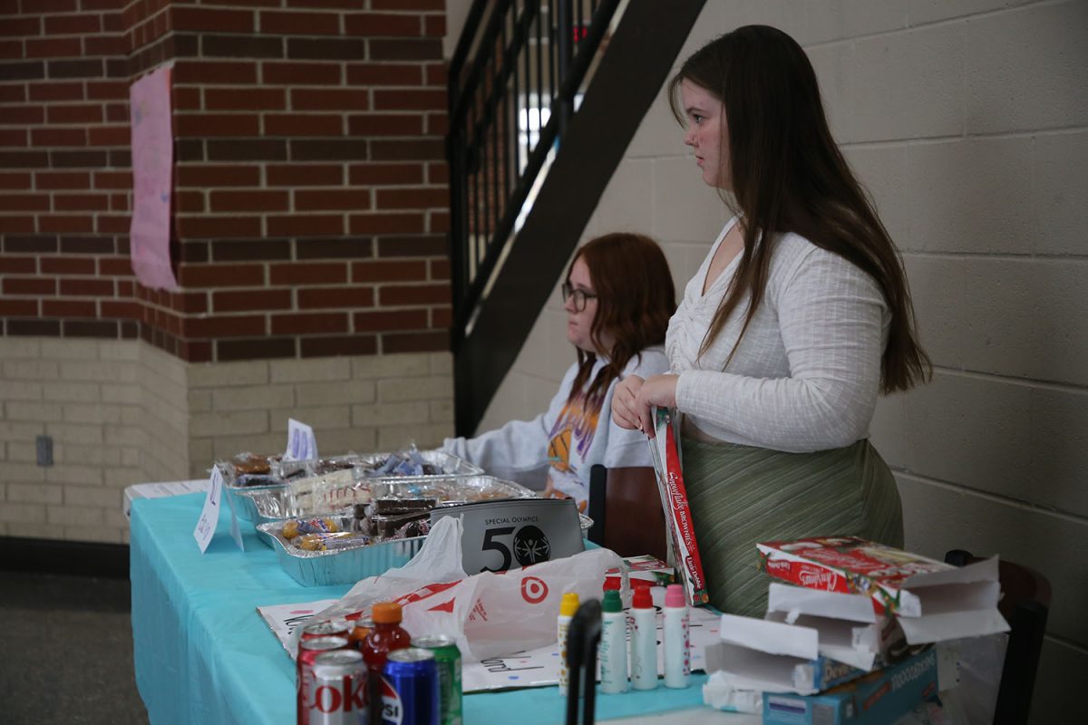 Organizing the items for the sale, Hannah Thompson and Rylee Hannah wait for students to purchase items from the bake sale. The bake sale was open during first through third hour, Nov. 13 through Nov. 17.