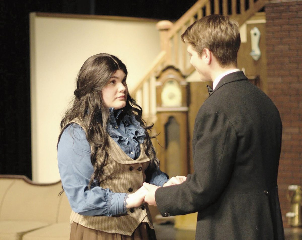 In the action. Actors Caroline Sikes, 12, and Jackson Wedel, 9, preform in the “Little Women” musical as Jo March and Friedrich Bhaer, moments before sharing a kiss.